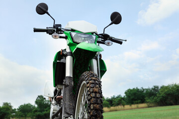 Fototapeta na wymiar Stylish cross motorcycle outdoors, low angle view