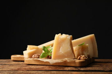 Delicious parmesan cheese with walnuts and basil on wooden table. Space for text