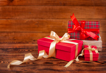 gift boxes with beautiful bows on a wooden background close-up