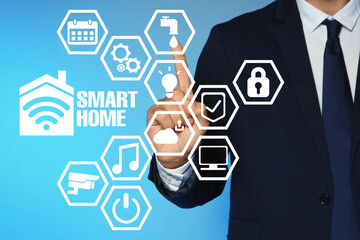 Man using digital screen with Smart Home interface on light blue background, closeup
