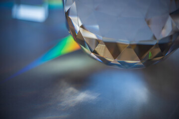 faceted glass sphere with light caustics and prism colors