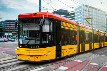 Naklejka na ściany i meble Modern tram on city street. Public transport