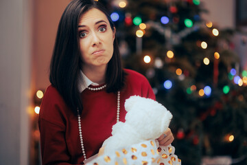Woman Unhappy with her Lousy Christmas Gift. Discontent girlfriend receiving an underwhelming...