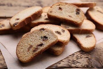 Sweet hard chuck crackers with raisins on wooden table, closeup