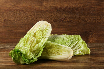 Cut fresh ripe Chinese cabbage on wooden table