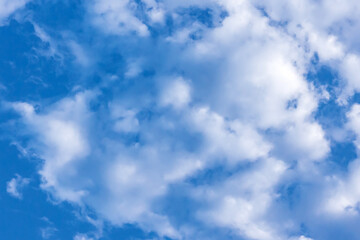 Clouds in the blue sky. Natural sky background texture, beautiful color. Peaceful blue sky with light clouds. The free form beauty of clouds and sky is perfect for background, backdrop and wallpaper.