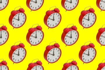Red alarm clocks on yellow background seamless pattern. 3d render