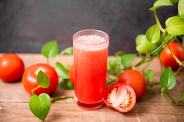 Fresh tomato juice on wooden table