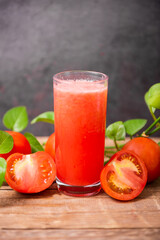 Fresh tomato juice on wooden table