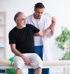 Old injured man visiting young doctor