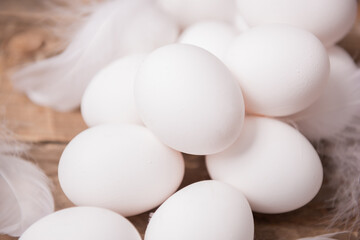 Fresh white eggs and feathers