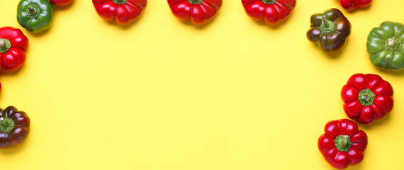 Composition with fresh bell peppers on yellow background with space for text