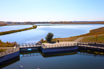 Pedestrian bridge perspective in the Canadian wetlands in autumn