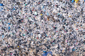 Top view. Lots of plastic bottles and rubbish. waste sorting site The concept of waste disposal and waste sorting to protect the environment.
