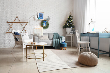 Interior of living room with fir tree decorated for Hanukkah celebration