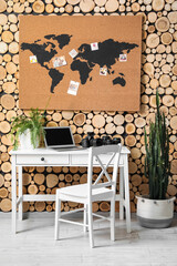 Interior of stylish office with photographer's workplace and world map