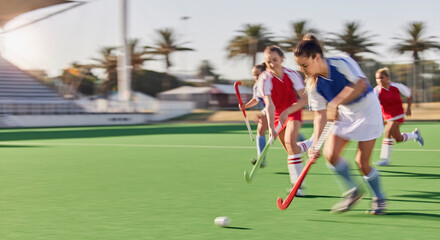 Sports, hockey and women in action on field playing game, match and training in outdoor stadium. Fitness, exercise and blur of female athletes running with speed for victory, winning and score goal