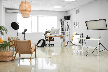 Interior of modern studio with photographer's workplace and equipment