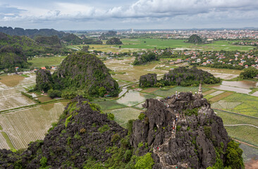 Lush green tropical forest mountains, village town, and Red River rice fields view at the Hang Mua Viewpoint in Ninh Binh Vietnam