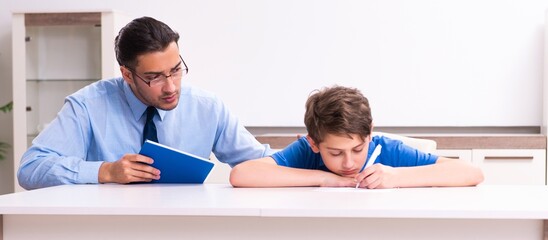 Busy father helping his son to prepare for exam