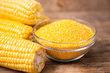 Corn grits polenta in a glass bowl on wooden table