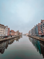 Panorama of Gdansk with beautiful old town over Motlawa river at fog, Poland.