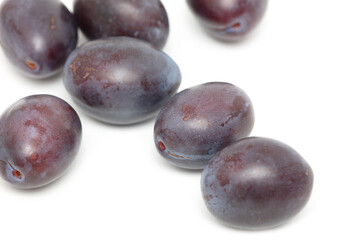 Ripe plum berries isolated on white background.