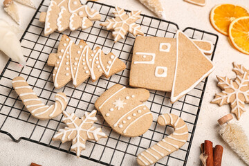 Grid with tasty Christmas cookies on light background, closeup