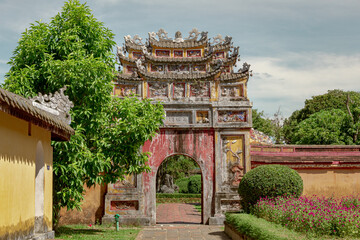 Colorful red and yellow stone gate design traditional architecture of the Hue Historic Citadel complex in Hue Vietnam