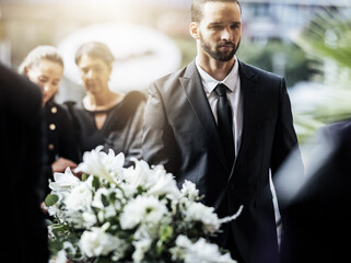 Death, funeral and carry coffin with family mourning, sad and depressed for grieving time. Grief...