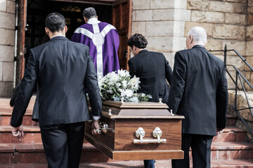 Death, funeral and holding coffin in church for grief, bereavement and with family together on steps. Grieving, sad and congregation in mourning, sad and with goodbye before burial and wood casket.