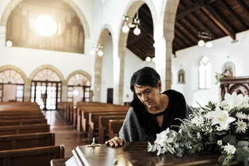 Widow, coffin and sad at a funeral feeling depression from death sitting in a church. Depressed...
