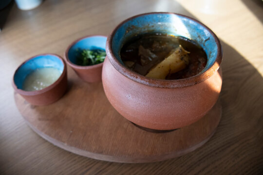 Georgian chanakhi in pots in the oven. Traditional Georgian dish with baked potatoes and meat.