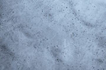 Gray textured cement wall background with fine concrete chips. Construction backgrounds.