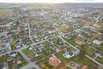 Aerial panoramic view on a little village in Europe, Sweden. Many private houses. Beautiful autumn sunlight, sunset. 