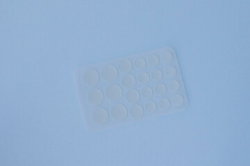The acne patches are clear on a blue background, flat on top.