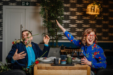 Woman hitting a man with a bouquet of flowers
