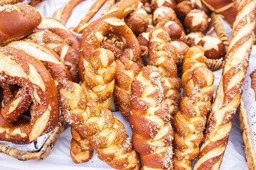 Freshly baked homemade soft pretzels with salt on wooden table. Perfect for Octoberfest