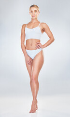 Fototapeta premium Body, fitness and underwear with a model woman in studio on a gray background to promote health or wellness. Exercise, beauty and portrait with a healthy young female inside for nutrition or diet