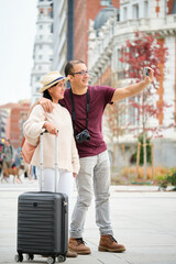 Multiracial couple of tourists taking a selfie together. Sightseeing in Madrid, Spain.