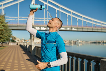 Tired runner pouring water on himself to cool down