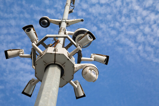 City pole with surveillance cameras. Street cameras against the sky.