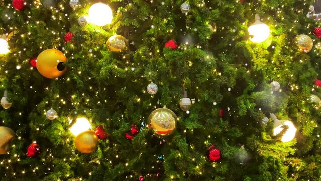 Animated Christmas tree with falling snowflakes .Christmas tree made animated particles. Christmas mood. Glittering effect.