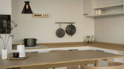 Copy space on minimal wooden dining table in the minimal white and wood kitchen interior style. © bongkarn