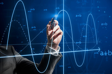 Close up of businessman hand with pen pointing at abstract glowing mathematical formula graph on blue background. Equation, digital data and mathematics app concept.