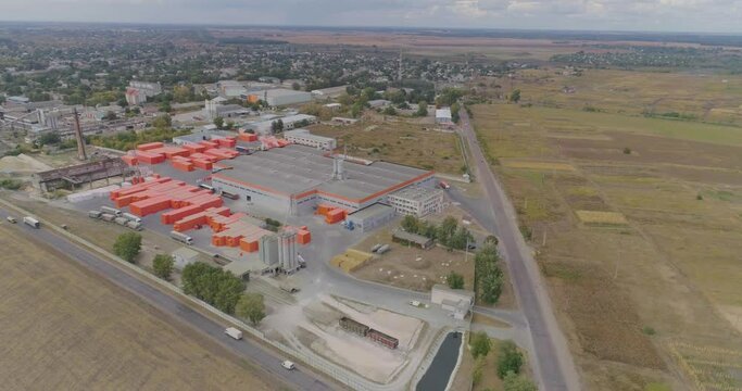 Exterior of new factory. dern factory in gray-orange colors from the air. Flight near modern factory