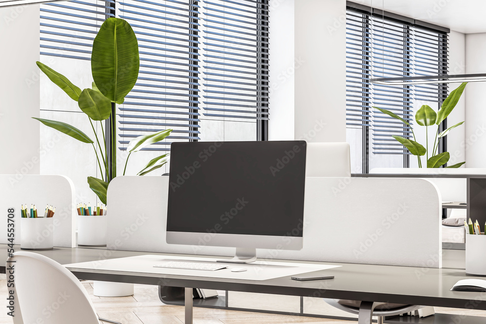 Poster Perspective view on blank black monitor on dark table with white partition in sunlit coworking office. 3D rendering, mock up
