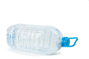 big plastic bottle with water lies on side isolated on white background