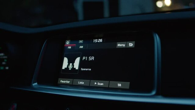 Close up car stereo radio tracking screen replacement green screen car driving early morning night time songs playing audio tuning in static noise podcast talking talk host voice level loud sound