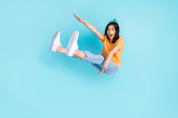 Full length photo of astonished girl person wear trendy clothes can fly rejoice want travel whole world isolated on blue color background - obrazy, fototapety, plakaty